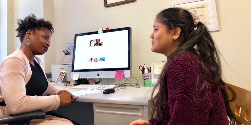 Briana Martin helping a student in her office at UVM.