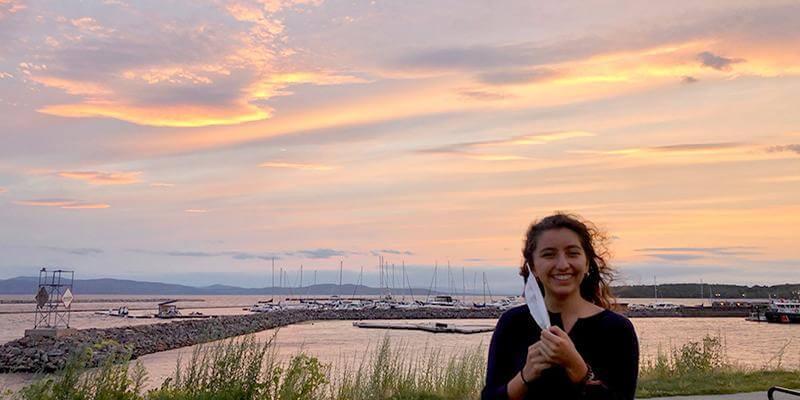 Julia LanzDuret-Hernandez at the waterfront in Burlington, Vermont at sunset.
