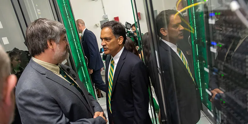 UVM president Garimella speaks with staff inside the VACC