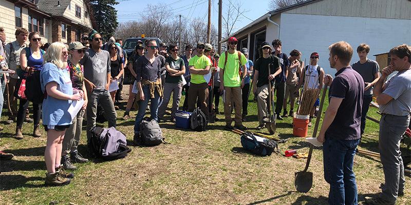 Large group of students get instructions at park entrance