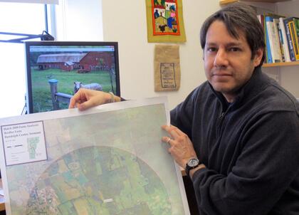 Ernesto Mendez shows a map of a participating farm whose conservation areas are identified.