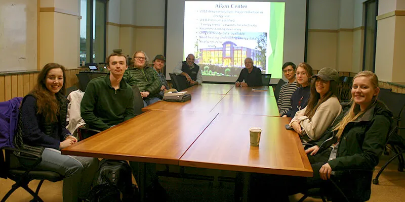 Students around table in conference room