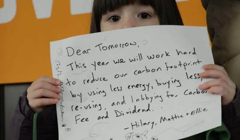 girl holding commitment to energy and carbon footprint reduction