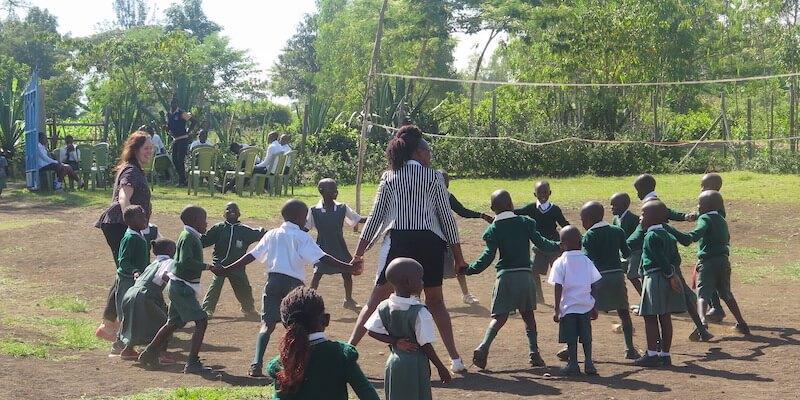 Children and teachers on school playground in Kenya
