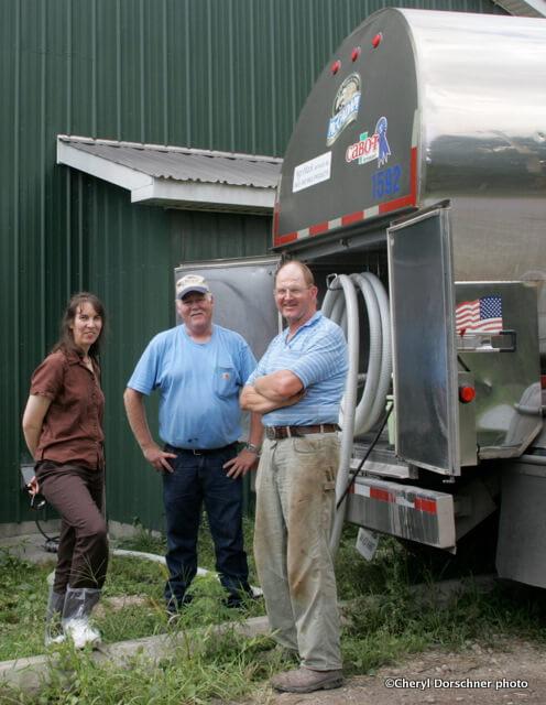 UVM researcher, farmer and milkman wait at the milkhouse while the bulk tank truck fills.