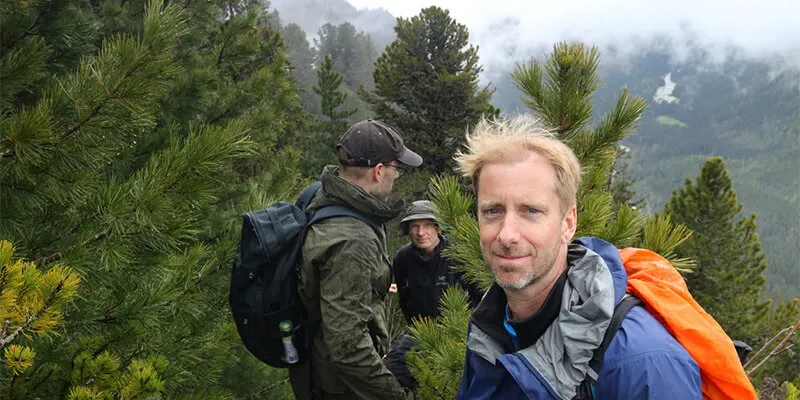 Three scientists in mountain forest