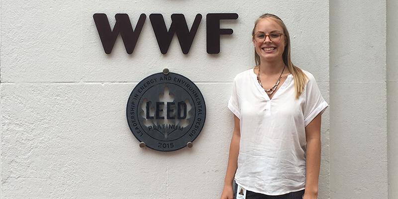 Leah Cawthorne stands next to World Wildlife Fund sign