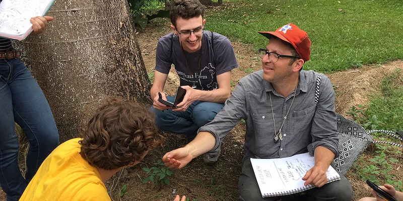 students and professor working with plants