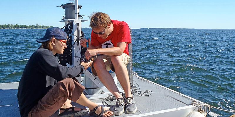 Courtney Giles and Peter Isles on floating platform in Lake Champlain's Missisquoi Bay.