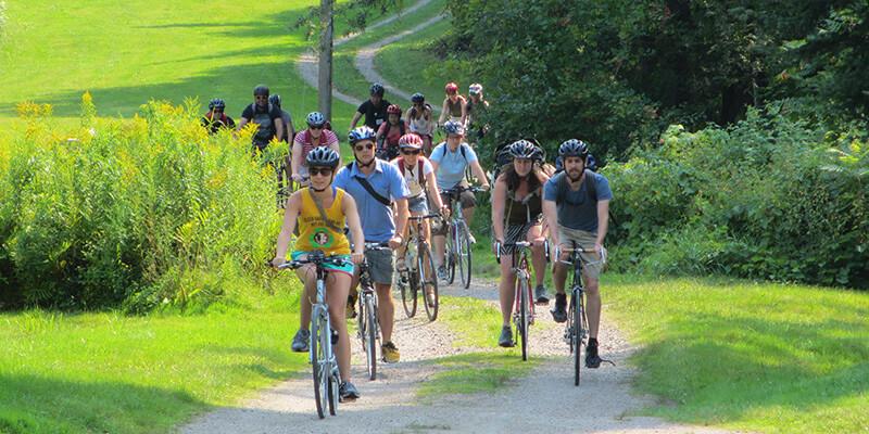 Students biking on Vermont dirt road