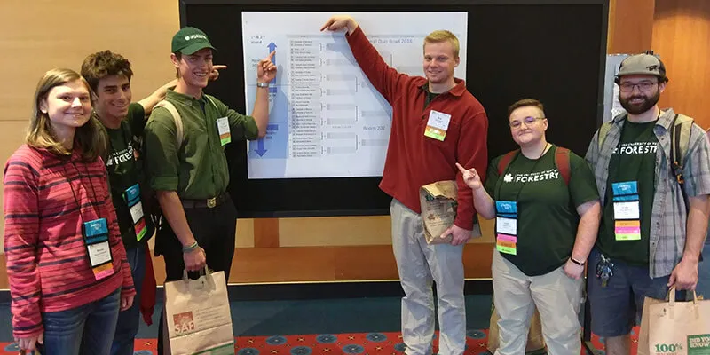 Students point to quiz bowl bracket diagram