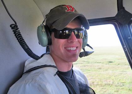 Ryan Sleeper inside an R-44 helicopter over the Alaskan tundra