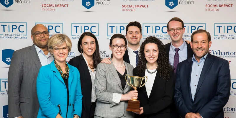 UVM’s SI-MBA team shows off their trophy with competition judges