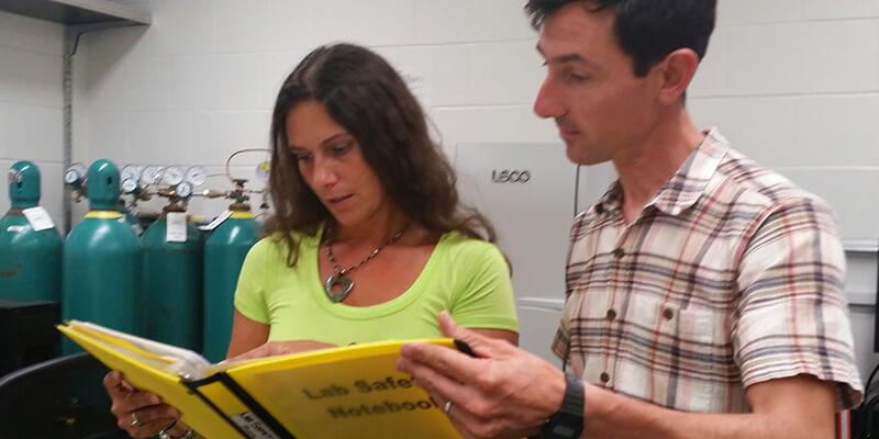 Sarah O'Sullivan and Ralph Tursini in a lab
