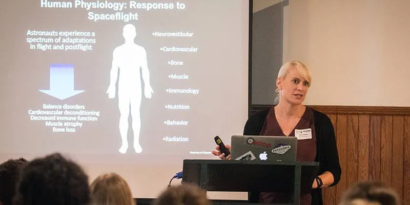 Kate Rubins presents a slide on the physiological response to spaceflight