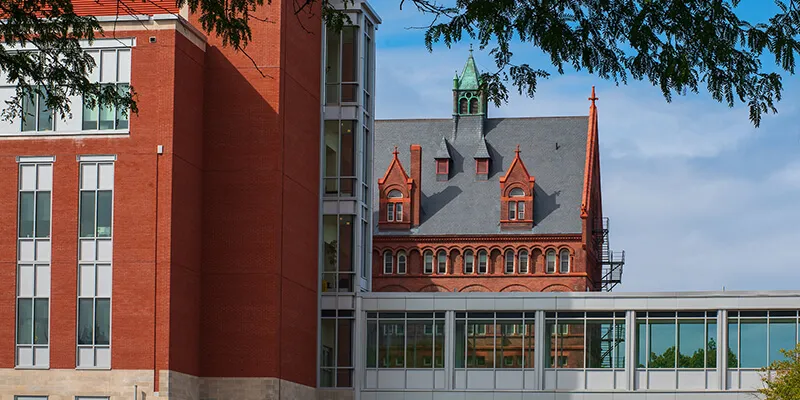 UVM's Discovery Hall building and a skybridge stand in front of Williams Hall 