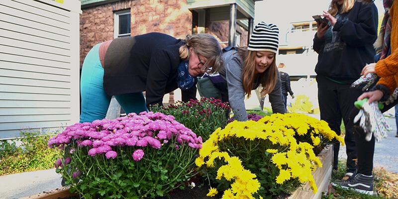 Neighbor and student garden together at corner of Isham Street and Hickok Place. 