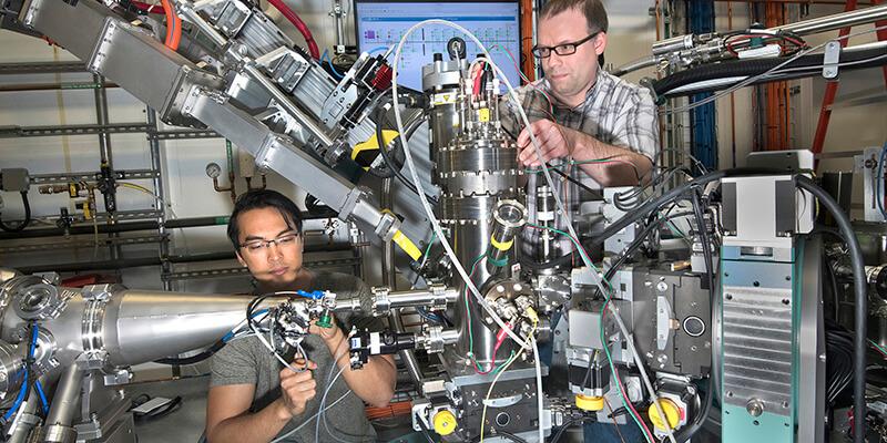 Two scientists work with high-tech equipment