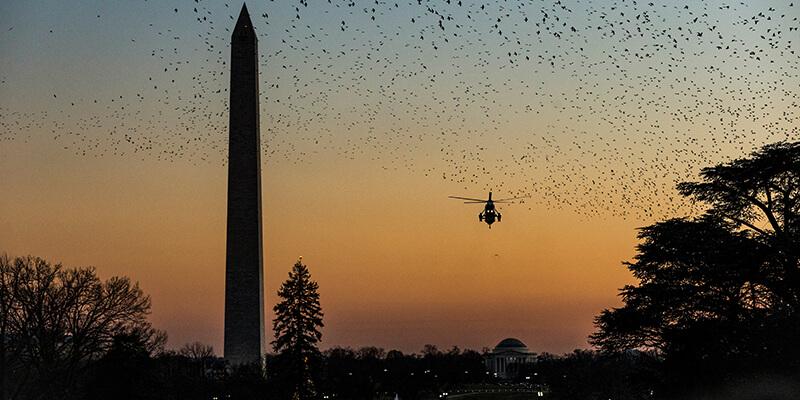 Washington Monument and Air Force One silhouetted at sunset