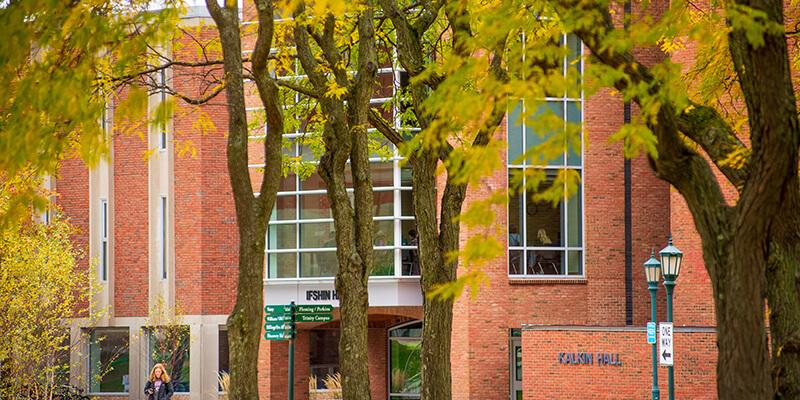 Grossman School of Business seen through the trees