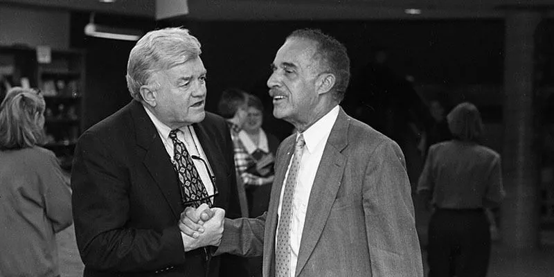 Then-president of UVM Tom Salmon and Lawrence McCrorey shaking hands.
