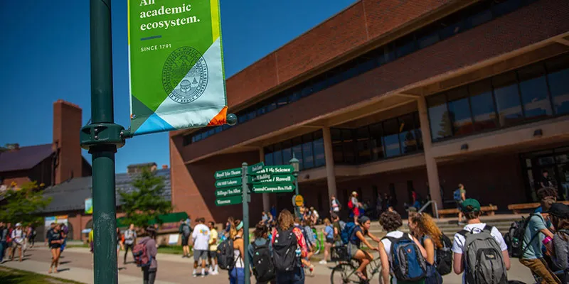 students pass by the main UVM library