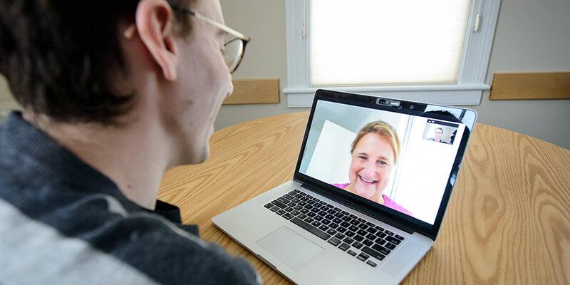 student talking on skype with mentor