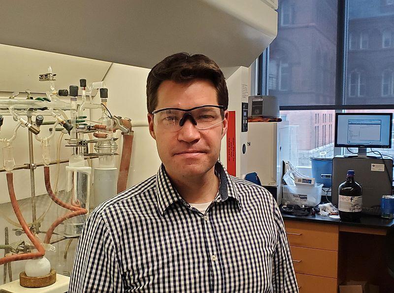 Rory Waterman standing in chemistry classroom 
