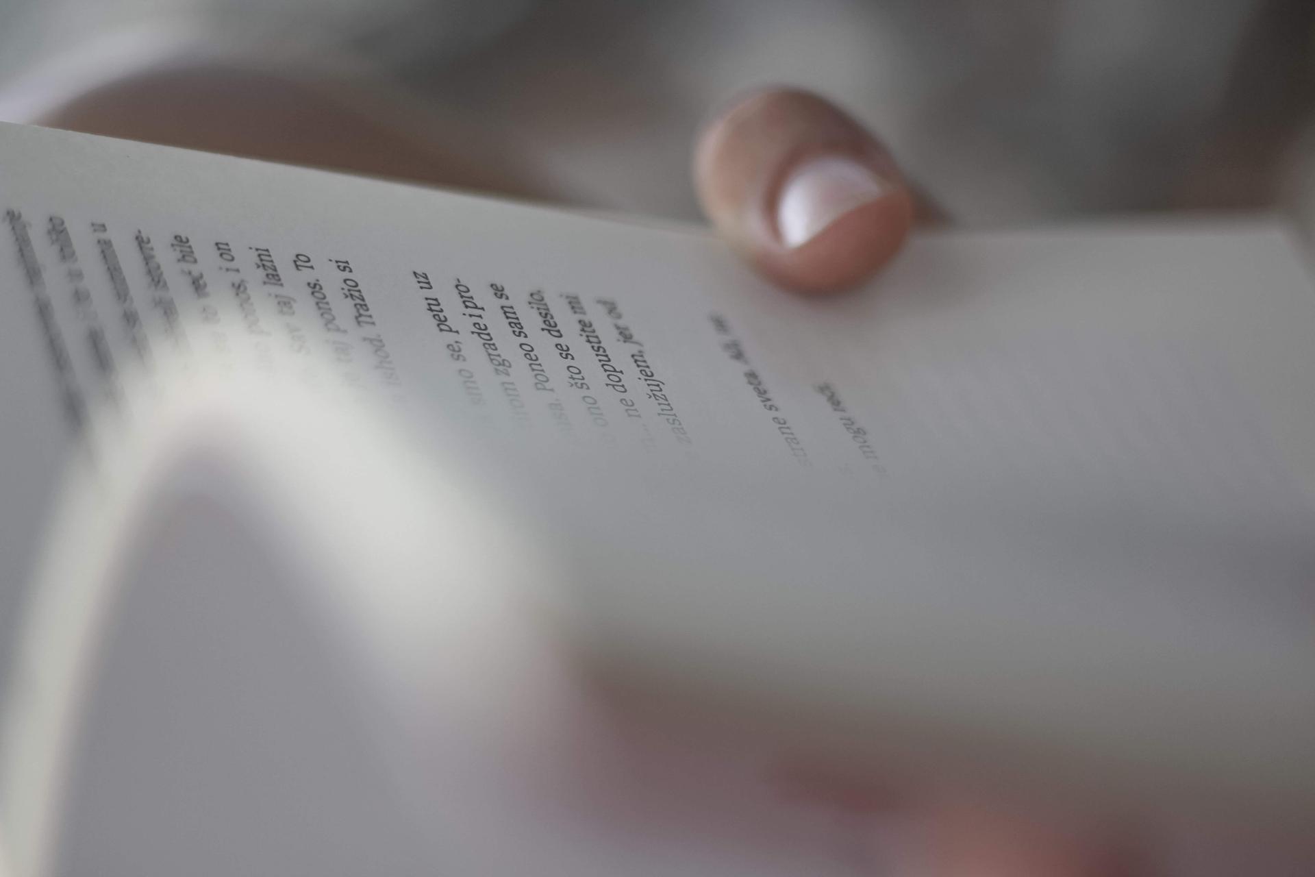 Hands holding a book of poetry