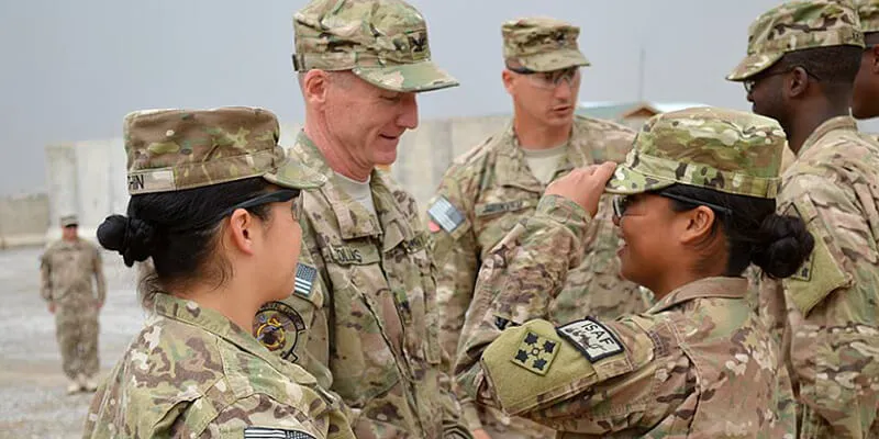 Stephanie Wobby salutes and smilies in uniform.