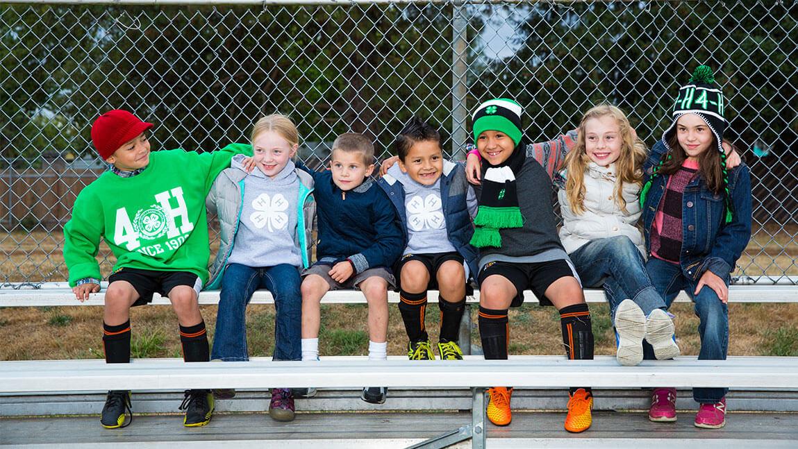 7 children sitting on a bench