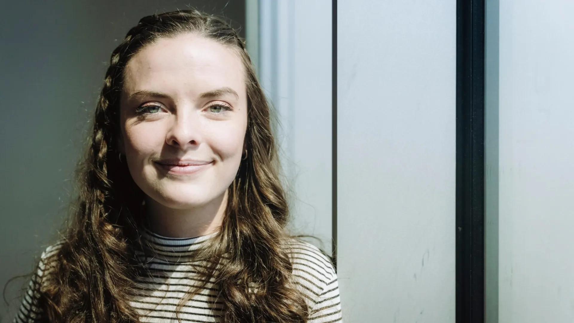 Bryn Loftness smiles in a conference room