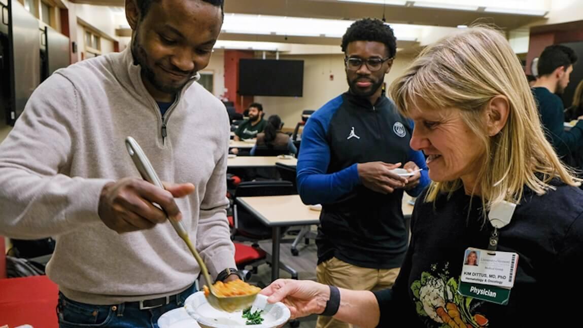 UVM medical student Benjamin Sebuufu '27 scoops soup for Dr. Kim Dittus and Jake Ayisi '27 during the culinary medicine pilot class at the Larner College of Medicine.