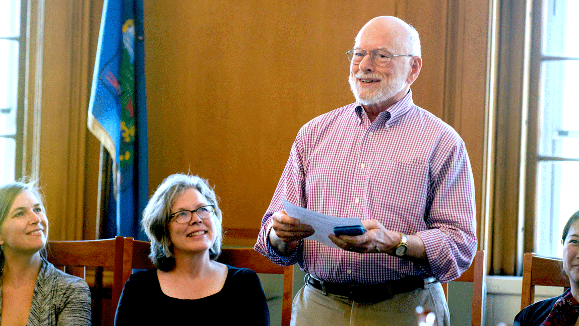 Professor Lawrence Shelton presents in conference room with faculty colleagues.