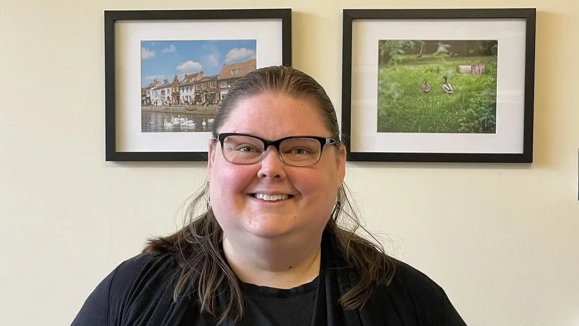 Woman in front of two paintings