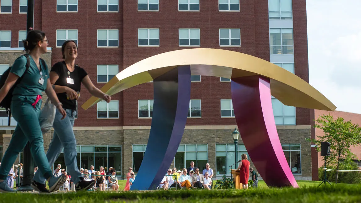 Students walking by Tango Sculpture
