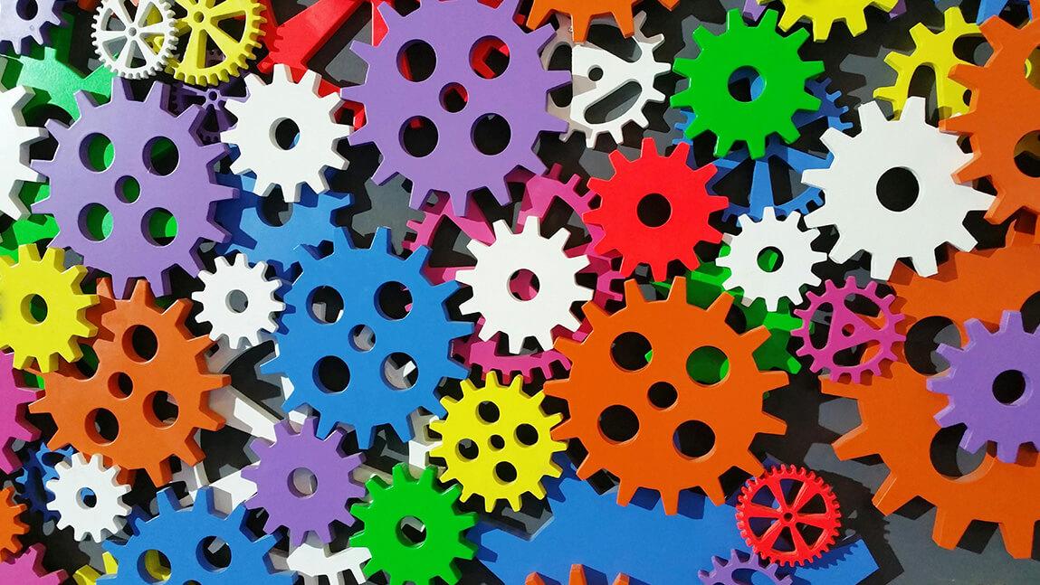 a whole lot of brightly colored gears tightly grouped