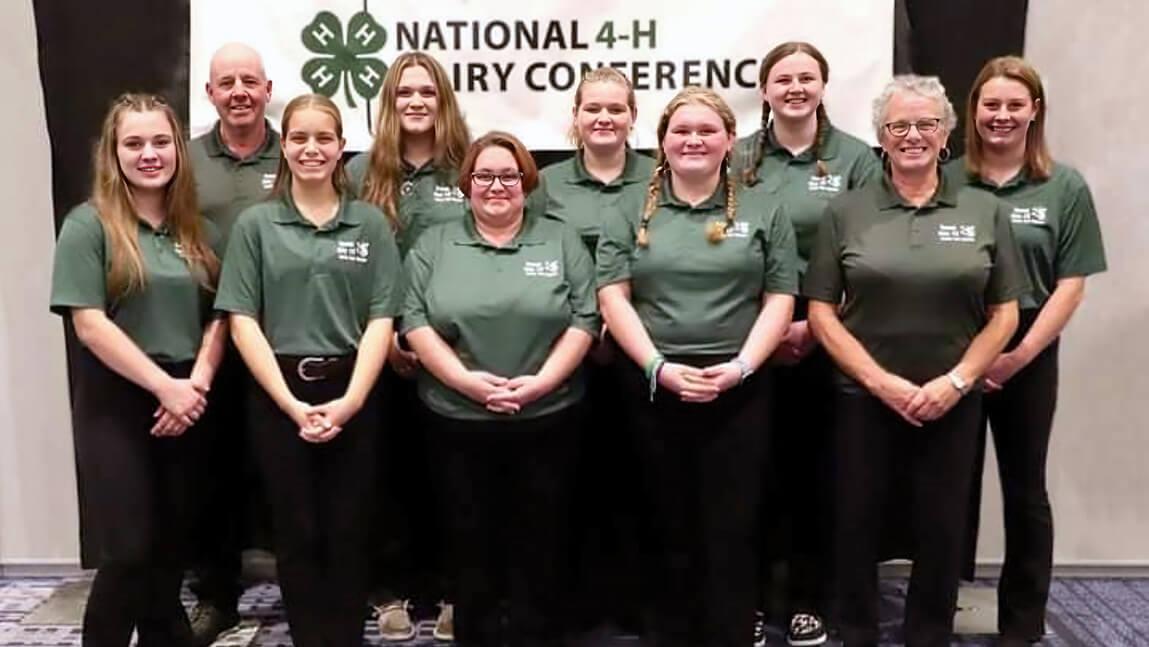 group of seven 4-H members and three adults wearing green shirts 