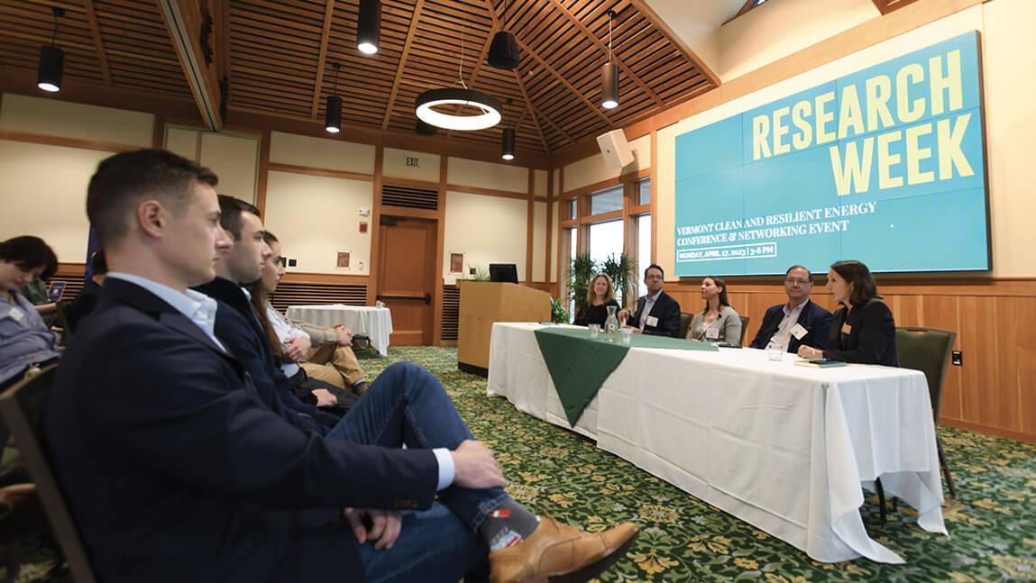 People watch a powerpoint presentation called Research Week
