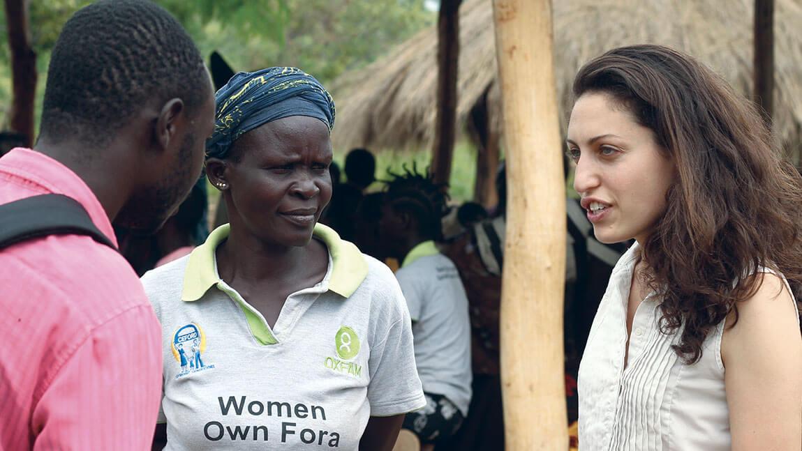 Sasha Fisher '10 speaking with two people in an outdoor setting in South Sudan