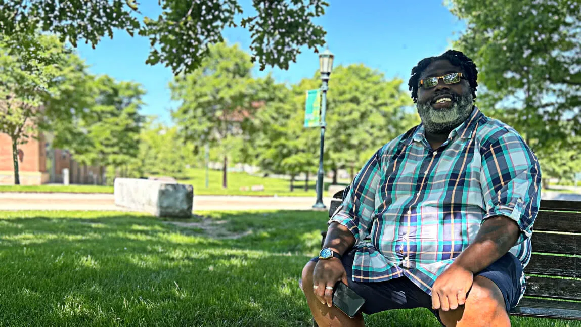 Mike Hill sitting on a bench