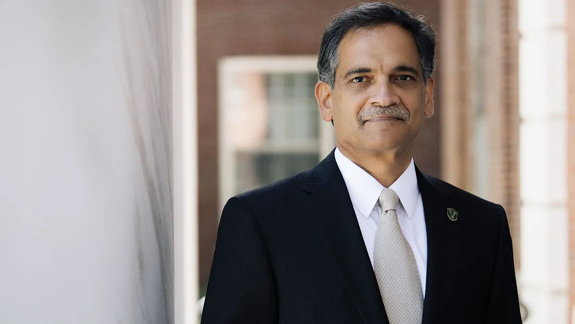 Suresh Garimella stands between two ivory columns