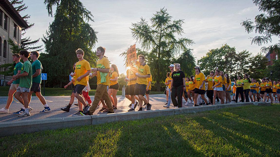 Students walk the path to the University Green for convocation