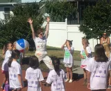 Demonstrating an exercise to a group of children.