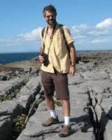 Guy standing on the top of the mountain 
