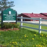 uvm sign in front of farm building