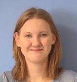 A woman with red hair and a grey shirt