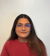 A woman with brown hair wearing a red shirt