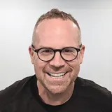 man wearing glasses and smiling