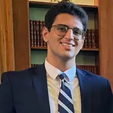 man wearing glasses and smiling